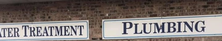 Water Treatment and Plumbing painted on the bay signs at the front of the store